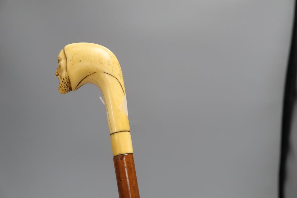 A Druids head carved cane, c.1860, length 85cm